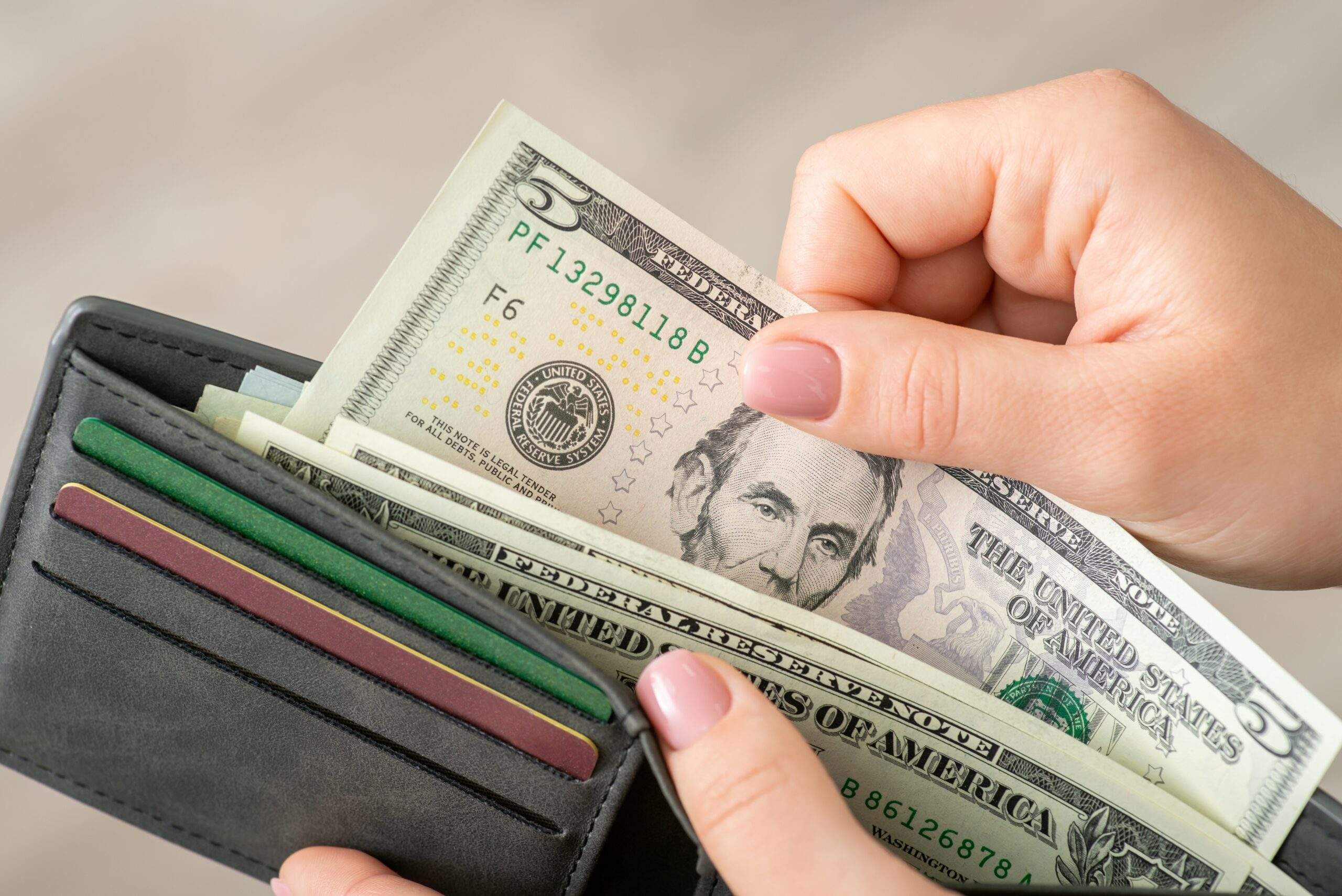 Handing over $5 bill