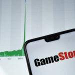 Picture of Gamestop Logo on Phone with graph trending up