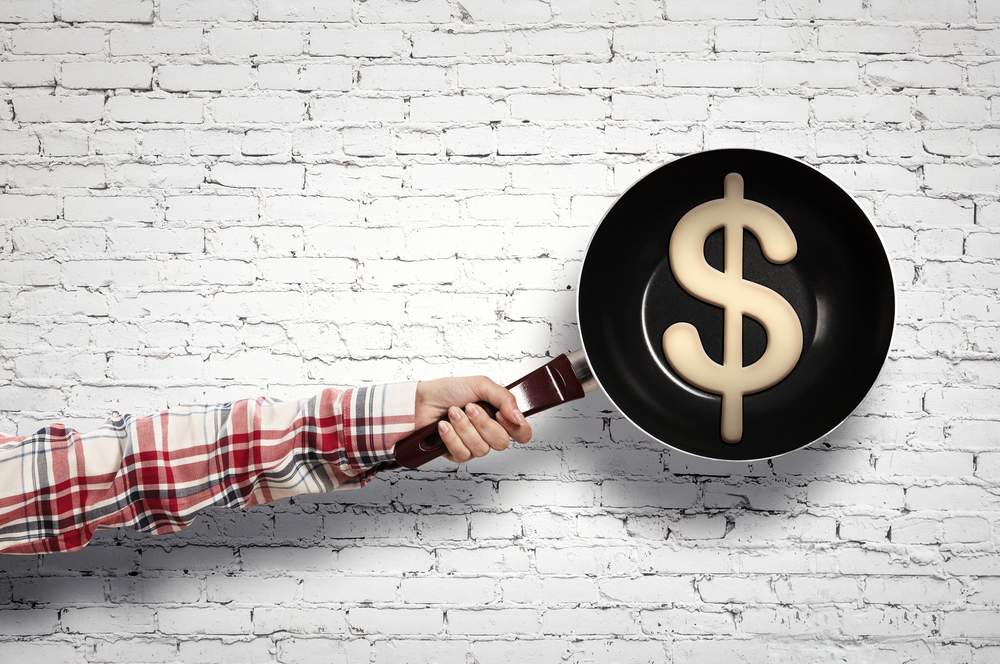Frying pan with money symbol
