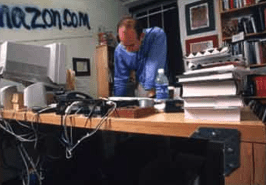 CEO Jeff Bezos working on his “desk” in his garage.