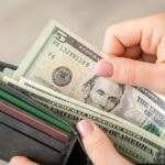 Handing over $5 bill