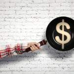 Frying pan with money symbol